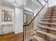 Inviting foyer with hardwood floors, staircase, and a decorative mirror at 2501 Richardson Dr, Charlotte, NC 28211