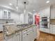 Modern kitchen featuring a center island with cooktop, stainless steel appliances, and custom cabinetry at 2501 Richardson Dr, Charlotte, NC 28211