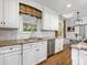 Well-lit kitchen with granite countertops, white cabinets, and stainless steel appliances at 2501 Richardson Dr, Charlotte, NC 28211