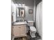 Functional bathroom with a granite vanity, a toilet, and a shower with a curtain at 2551 Glenwood St, Kannapolis, NC 28083