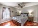 Comfortable bedroom with wood floors, a ceiling fan, and a large window at 2551 Glenwood St, Kannapolis, NC 28083