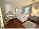Charming bedroom with a white iron bed frame, vintage vanity, and hardwood floors for a cozy feel at 2600 Kirkholm Dr, Matthews, NC 28105