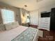 Comfortable bedroom featuring a white dresser, hardwood floors, and closet space with ample storage at 2600 Kirkholm Dr, Matthews, NC 28105