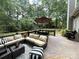 Inviting outdoor deck area featuring a comfortable sectional, coffee table, and umbrella-covered dining set at 2600 Kirkholm Dr, Matthews, NC 28105
