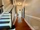 Traditional foyer with hardwood floors, staircase, and a view into other rooms through an arched doorway at 2600 Kirkholm Dr, Matthews, NC 28105