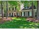 Charming two-story home featuring a manicured lawn, red front door, and beautiful landscaping at 2600 Kirkholm Dr, Matthews, NC 28105