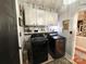 Well-organized laundry room with upper cabinets, shelf, modern washer and dryer, and decorative rug at 2600 Kirkholm Dr, Matthews, NC 28105