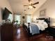 Vaulted bedroom featuring a beautiful dark bed frame and matching dresser with a ceiling fan at 2600 Kirkholm Dr, Matthews, NC 28105