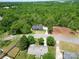 Stunning aerial view of the home nestled in a lush, wooded area with a circular driveway at 2694 Woodcrest Sw Dr, Concord, NC 28027