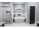 Modern bathroom features a standalone tub, marble tile, and glass-enclosed shower at 2694 Woodcrest Sw Dr, Concord, NC 28027