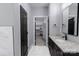 Bathroom with granite countertops, dark cabinets, and walk-in closet at 2694 Woodcrest Sw Dr, Concord, NC 28027