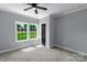 Bedroom showcasing carpeted floors, a ceiling fan, and natural light from windows at 2694 Woodcrest Sw Dr, Concord, NC 28027