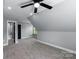 Spacious bonus room offering neutral carpet, large window, and adjacent bathroom at 2694 Woodcrest Sw Dr, Concord, NC 28027