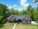 Charming single-Gathering home featuring a well-manicured lawn, gray siding and a walkway leading to the front entrance at 2694 Woodcrest Sw Dr, Concord, NC 28027