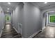 Hallway featuring luxury vinyl plank floors and access to a staircase at 2694 Woodcrest Sw Dr, Concord, NC 28027