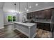 Bright kitchen with a center island, stainless appliances, granite countertops, and dark wood cabinetry at 2694 Woodcrest Sw Dr, Concord, NC 28027