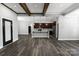 Open-concept kitchen with an island, stainless steel appliances, pendant lighting and views to living spaces at 2694 Woodcrest Sw Dr, Concord, NC 28027