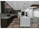 Well-appointed kitchen featuring stainless steel appliances, a center island, dark cabinetry and modern pendant lighting at 2694 Woodcrest Sw Dr, Concord, NC 28027