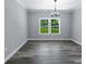 Bright living room with hardwood floors and natural light streaming through the double window at 2694 Woodcrest Sw Dr, Concord, NC 28027