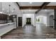 Open-concept living room features hardwood floors, wooden ceiling beams, and a modern kitchen at 2694 Woodcrest Sw Dr, Concord, NC 28027