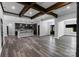 Spacious home with open kitchen, living room, hardwood floors, stone fireplace, and exposed beams at 2694 Woodcrest Sw Dr, Concord, NC 28027