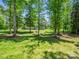 Large yard features expansive grassy area and home surrounded by trees at 270 Conifer Way, Shelby, NC 28150