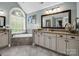 Well-lit bathroom featuring dual vanities, large mirror, soaking tub, and modern fixtures at 270 Conifer Way, Shelby, NC 28150