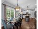 Charming dining area with stylish chandelier, table setting, and view to kitchen at 270 Conifer Way, Shelby, NC 28150