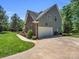 Stylish home exterior showcasing brick accents, a garage, and manicured landscaping at 270 Conifer Way, Shelby, NC 28150