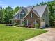 Well-manicured lawn compliments this two-story home with gray and brick exterior, and attached two car garage at 270 Conifer Way, Shelby, NC 28150