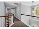 Upstairs hallway featuring fresh neutral paint, carpet, and an eye-catching light fixture hanging near the window at 270 Conifer Way, Shelby, NC 28150