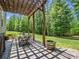 Inviting outdoor patio features a pergola, dining table, and beautifully landscaped backyard at 270 Conifer Way, Shelby, NC 28150