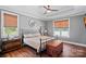 Comfortable bedroom featuring a wrought iron bed, hardwood floors and tray ceiling at 270 Worthington Dr, Mt Ulla, NC 28125