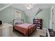 Bedroom featuring vaulted ceiling, fan, bookshelf, and large window at 270 Worthington Dr, Mt Ulla, NC 28125