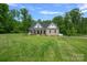 Charming exterior of a well-manicured home with a covered porch, set on a lush green lawn at 270 Worthington Dr, Mt Ulla, NC 28125