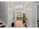 Bright and inviting foyer with hardwood floors, showcasing a beautiful wooden front door and stylish light fixture at 270 Worthington Dr, Mt Ulla, NC 28125