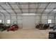 Spacious garage interior with ample room for equipment and storage with a rolling metal door at 270 Worthington Dr, Mt Ulla, NC 28125