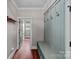 Hallway featuring custom storage bench and hooks, and wood flooring at 270 Worthington Dr, Mt Ulla, NC 28125