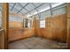Interior stall with wooden walls, metal bars, a small window and concrete floor at 270 Worthington Dr, Mt Ulla, NC 28125