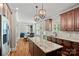 Spacious kitchen with granite countertops, stainless appliances, and dark wood cabinets, open to the living room at 270 Worthington Dr, Mt Ulla, NC 28125