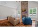 Bright living room with a stone fireplace, wood floors, and comfortable seating arrangement at 270 Worthington Dr, Mt Ulla, NC 28125