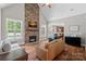 Inviting living room with a stone fireplace, wood floors, and access to the kitchen and backyard pool at 270 Worthington Dr, Mt Ulla, NC 28125