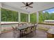 Inviting covered patio with a dining table, fan, and views of the backyard pool at 270 Worthington Dr, Mt Ulla, NC 28125