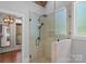 Bathroom shower with glass surround, rainfall shower head and stone tile at 270 Worthington Dr, Mt Ulla, NC 28125