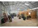 Spacious interior stables with wooden stalls, equipment, and ample room for various activities at 270 Worthington Dr, Mt Ulla, NC 28125