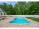 Backyard in-ground pool surrounded by a concrete deck and lush greenery at 270 Worthington Dr, Mt Ulla, NC 28125