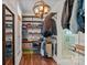 Walk-in closet featuring custom shelves, wooden racks and unique lighting fixture at 270 Worthington Dr, Mt Ulla, NC 28125