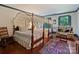 Spacious bedroom featuring canopy beds, hardwood floors, and seating area at 3040 Valencia Ter, Charlotte, NC 28211