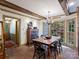 Charming dining area with brick flooring, exposed wooden beams, and large windows providing natural light at 3040 Valencia Ter, Charlotte, NC 28211