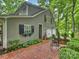 Home exterior featuring a brick walkway, landscaped garden beds, and a two-car garage at 3040 Valencia Ter, Charlotte, NC 28211